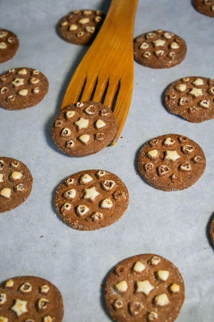 Chocolate cookies with white chocolate chips and nuts.